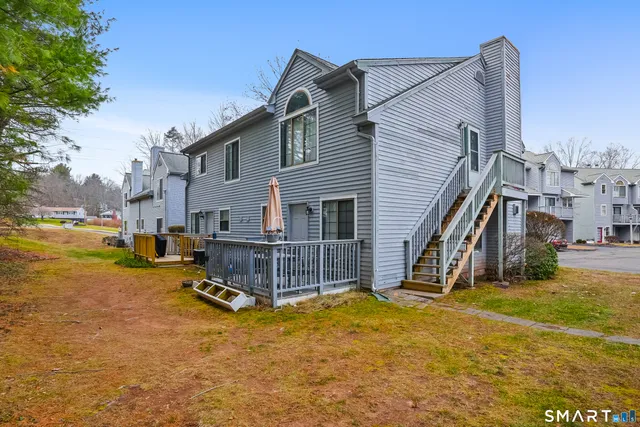 a front view of a house with yard and staircase