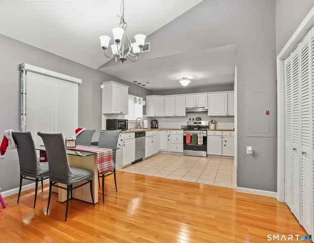 a living room with stainless steel appliances kitchen island granite countertop furniture and a dining table