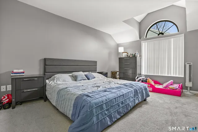 a bedroom with a bed and a dresser