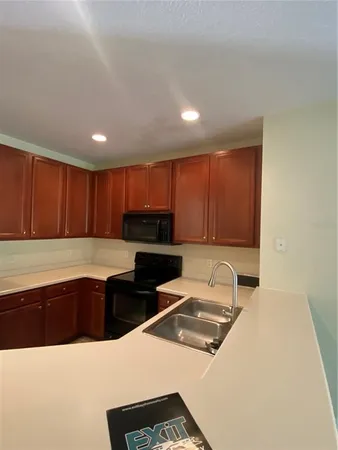 a kitchen with stainless steel appliances kitchen island granite countertop a sink and cabinets