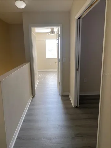 a view of a hallway with wooden floor