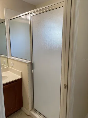 a bathroom with a shower and a sink