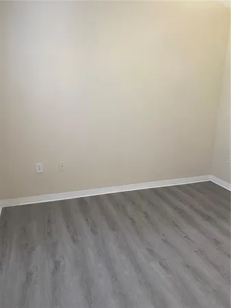 an empty room with wooden floor