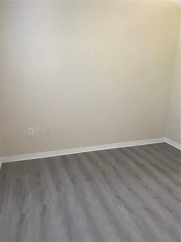 an empty room with wooden floor