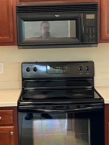 a stove top oven sitting inside of a kitchen