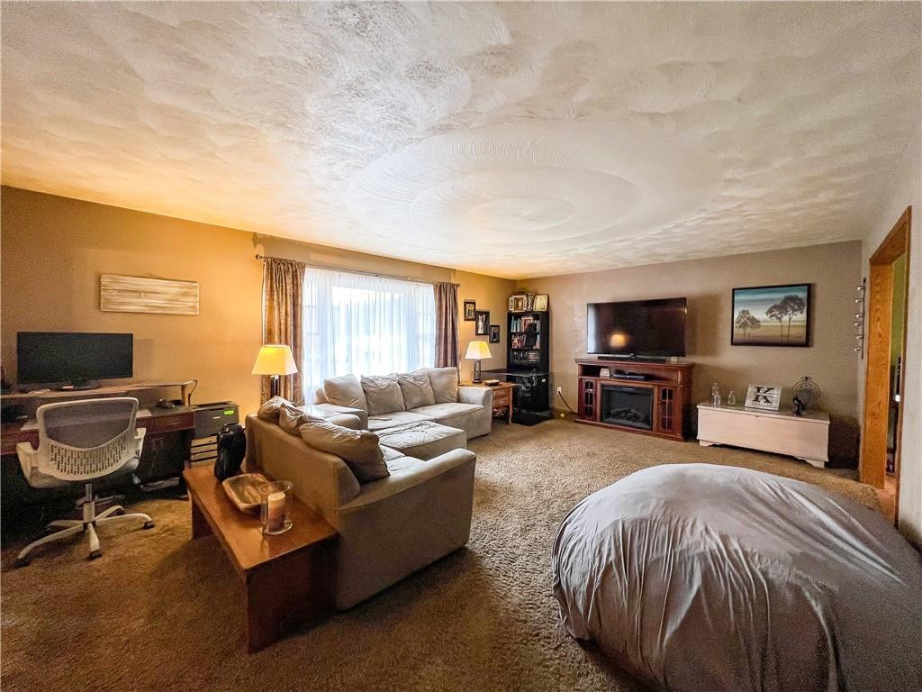 212 Meridian Road Butler, PA 16001 - Photo 3 of 25 a spacious bedroom with a bed and a flat screen tv