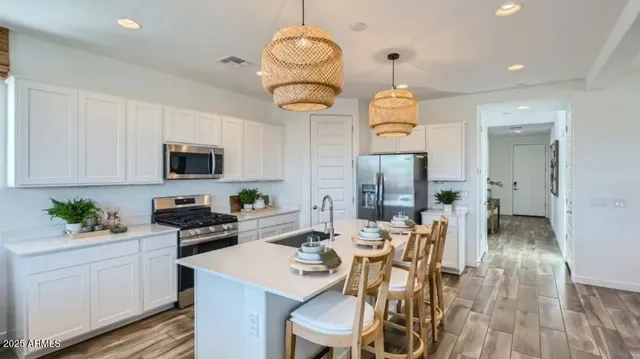 a kitchen with a sink stove and refrigerator