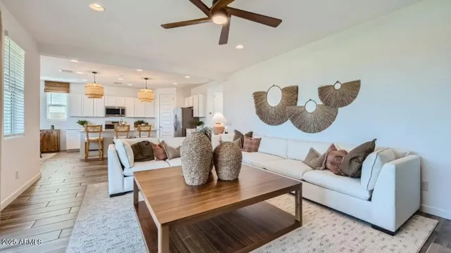 a kitchen with stainless steel appliances kitchen island granite countertop a stove a microwave a dining table and chairs with wooden floor