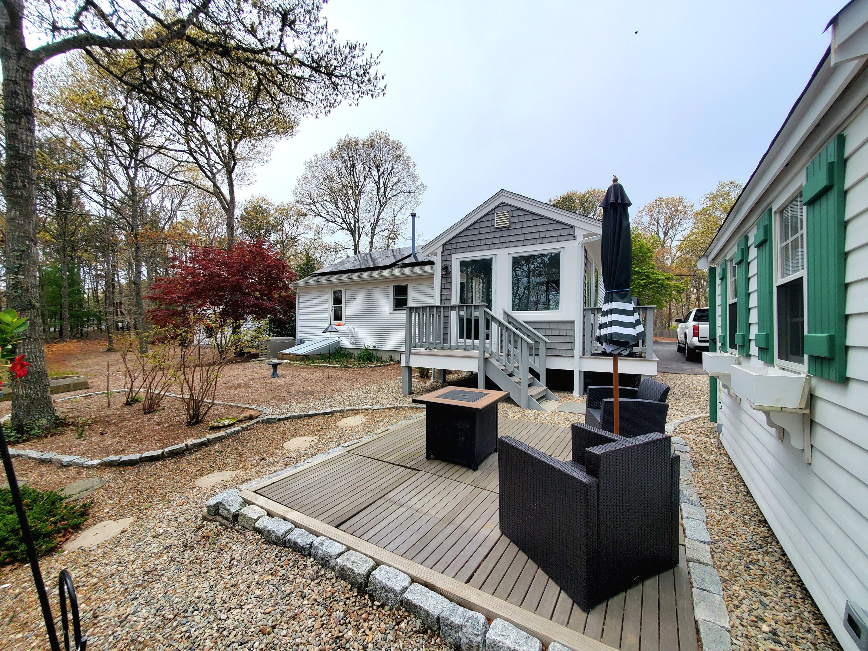 52 Thayer Road Dennis, MA 02660 - Photo 2 of 19 a view of a house with couches on the patio