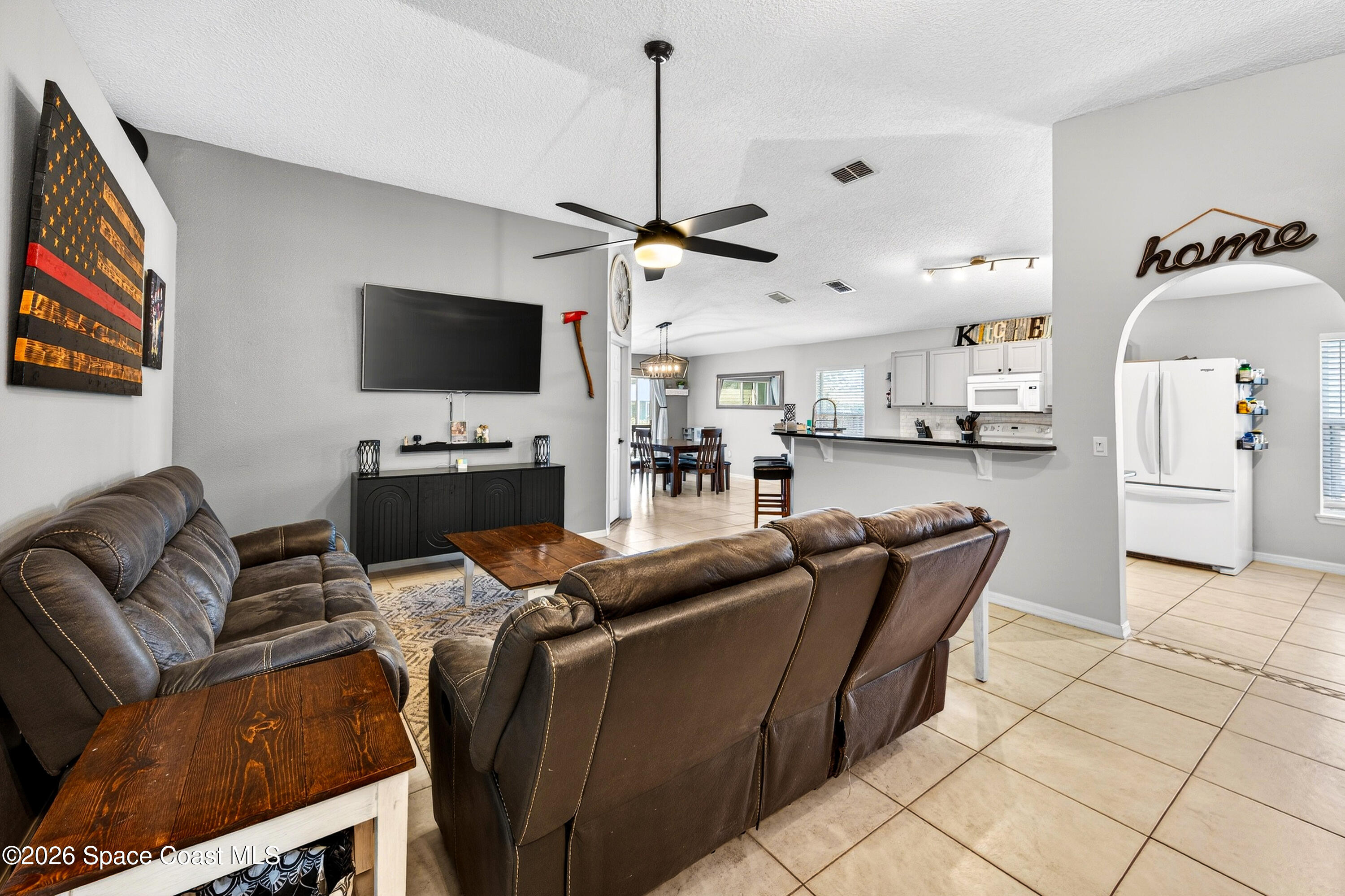 3393 Echo Ridge Place Cocoa, FL 32926 - Photo 11 of 40 a living room with furniture and a flat screen tv