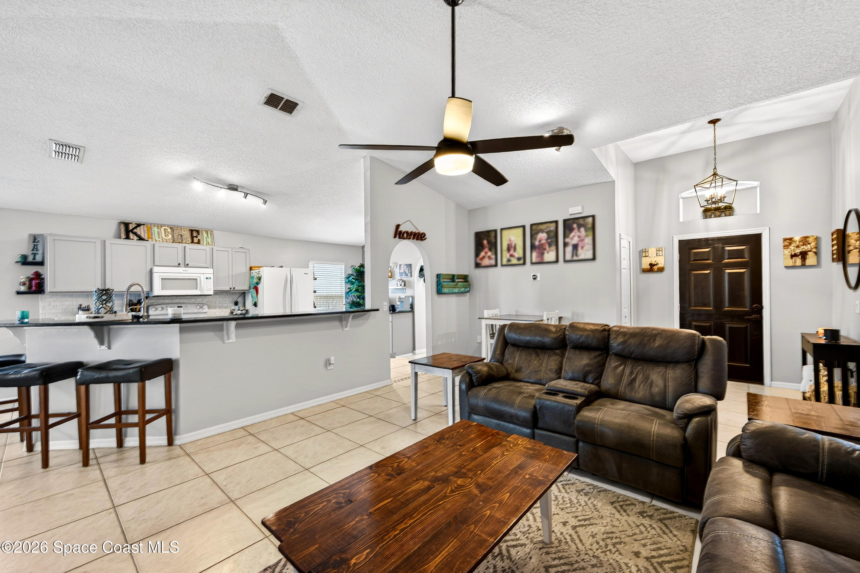 3393 Echo Ridge Place Cocoa, FL 32926 - Photo 12 of 40 a living room with furniture and kitchen view