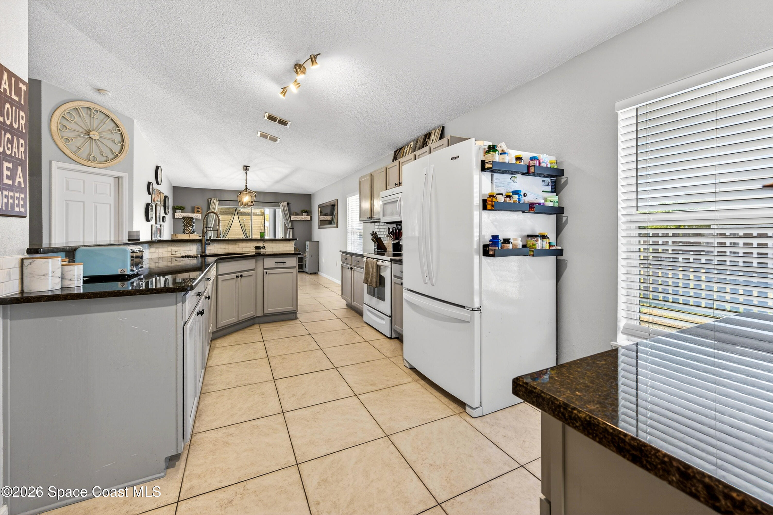 3393 Echo Ridge Place Cocoa, FL 32926 - Photo 15 of 40 a kitchen with stainless steel appliances granite countertop a refrigerator and a stove top oven