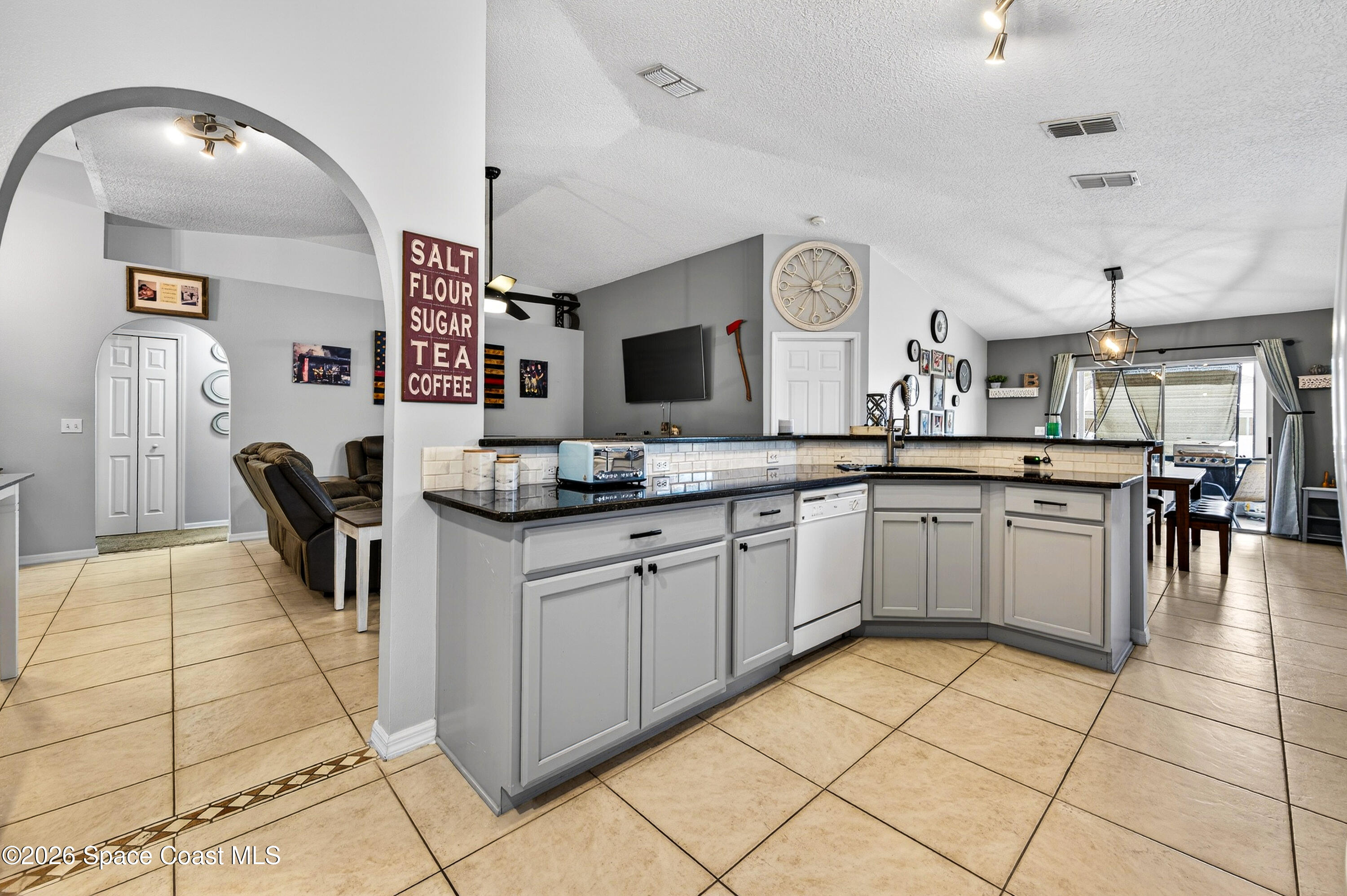3393 Echo Ridge Place Cocoa, FL 32926 - Photo 16 of 40 a large white kitchen with a sink and cabinets