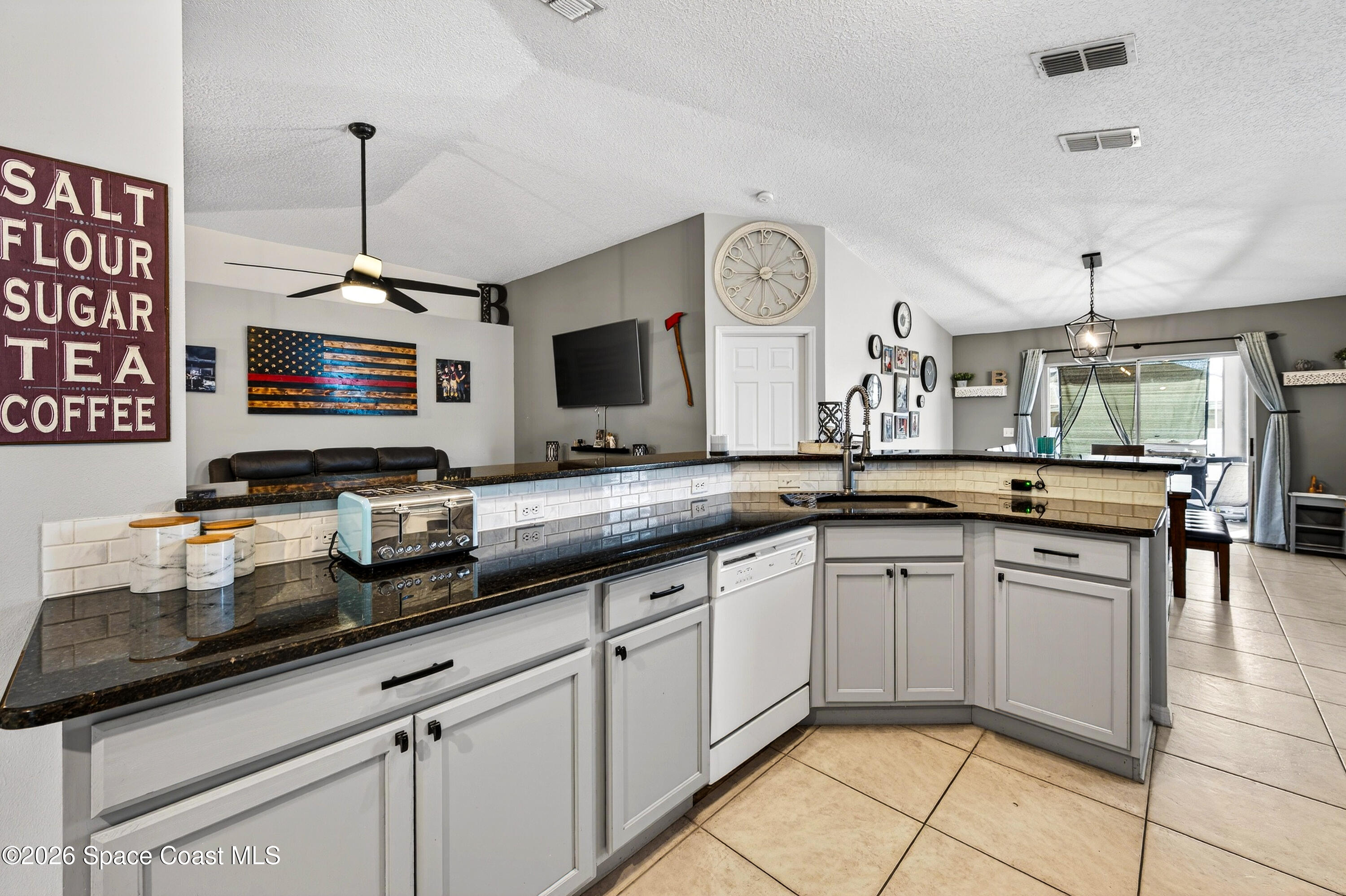 3393 Echo Ridge Place Cocoa, FL 32926 - Photo 17 of 40 a kitchen with stainless steel appliances granite countertop a sink and a stove