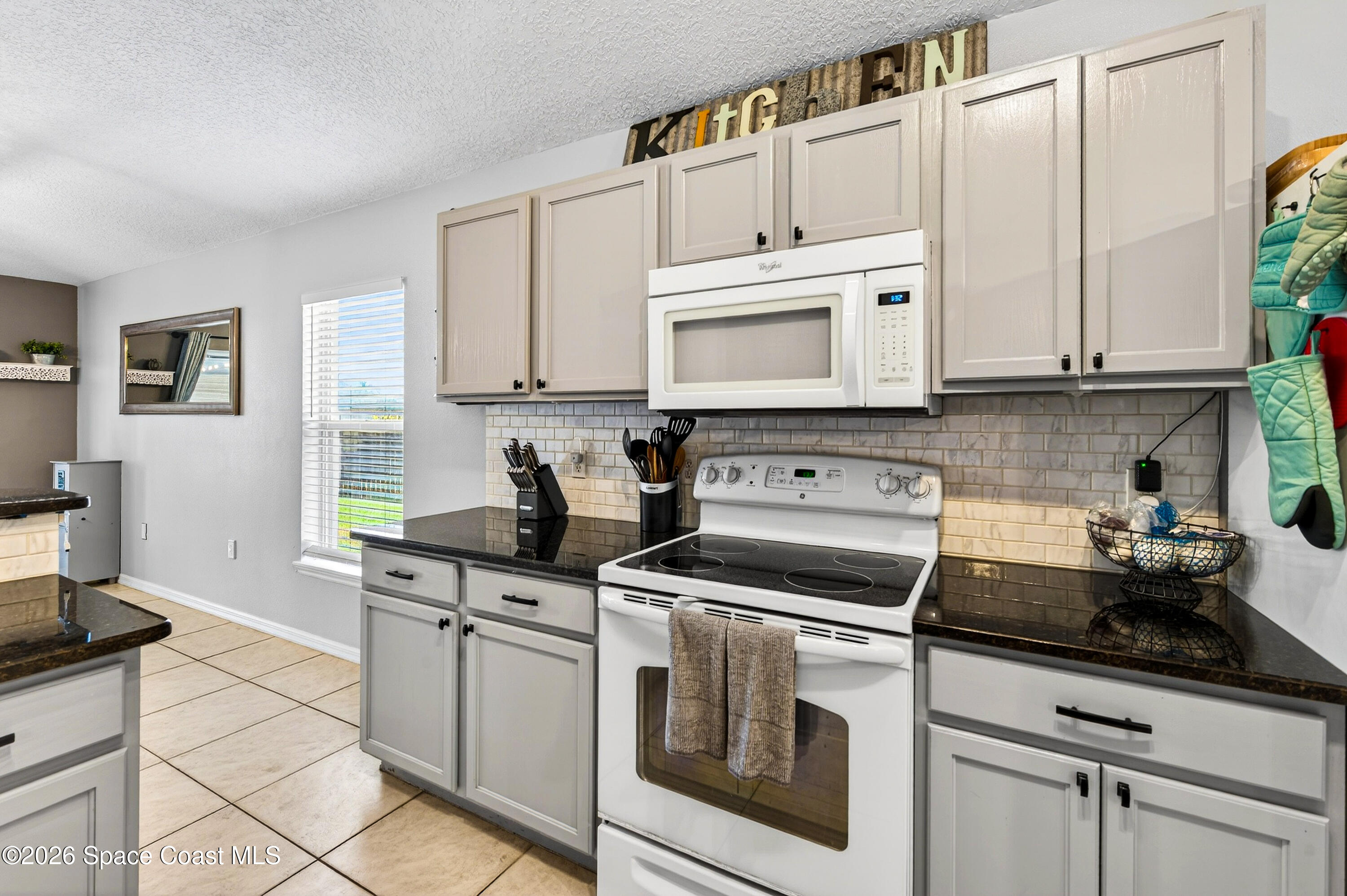 3393 Echo Ridge Place Cocoa, FL 32926 - Photo 18 of 40 a kitchen with cabinets appliances a sink and a counter top space
