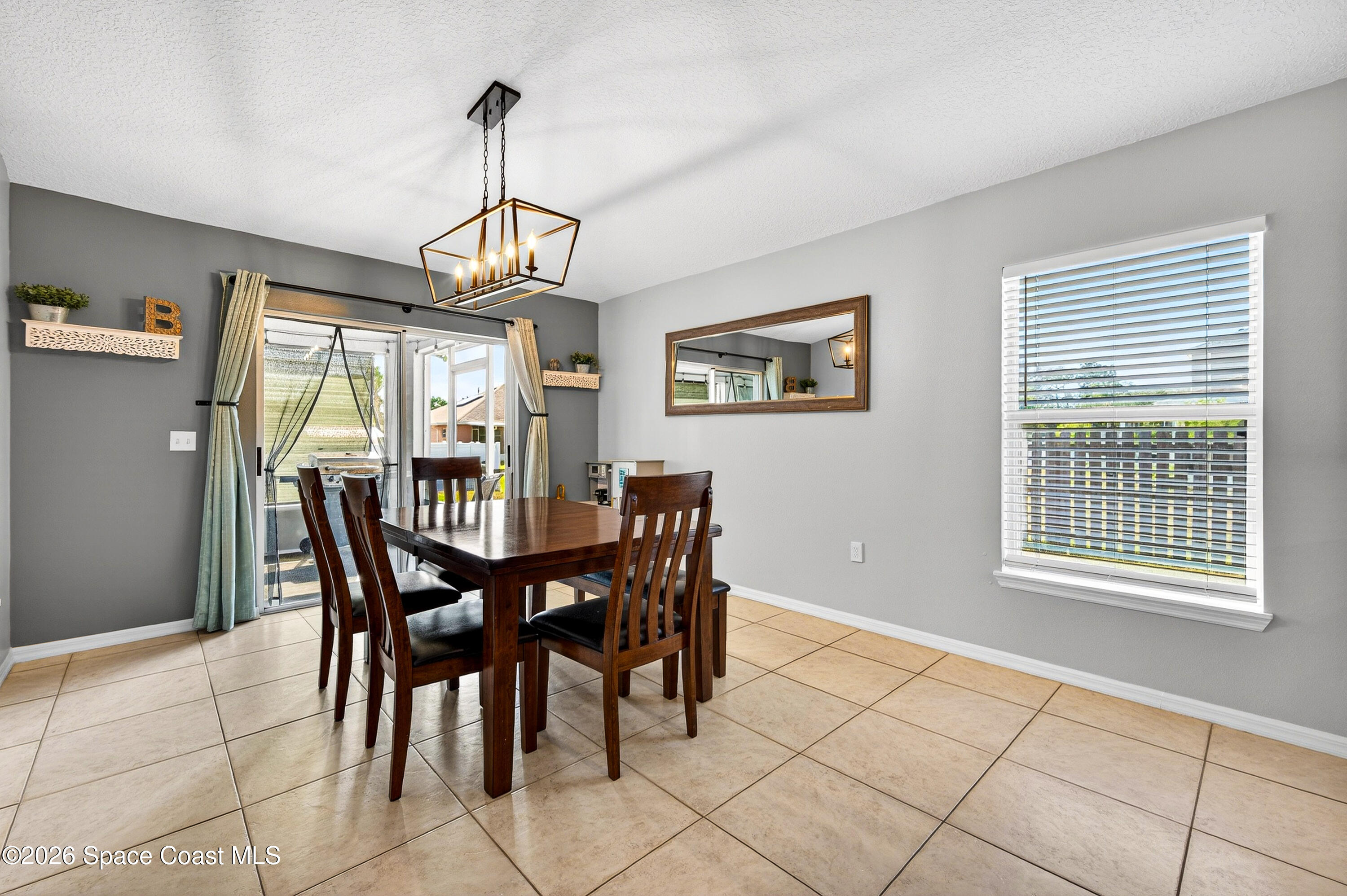 3393 Echo Ridge Place Cocoa, FL 32926 - Photo 20 of 40 a view of a dining room with furniture window and outside view