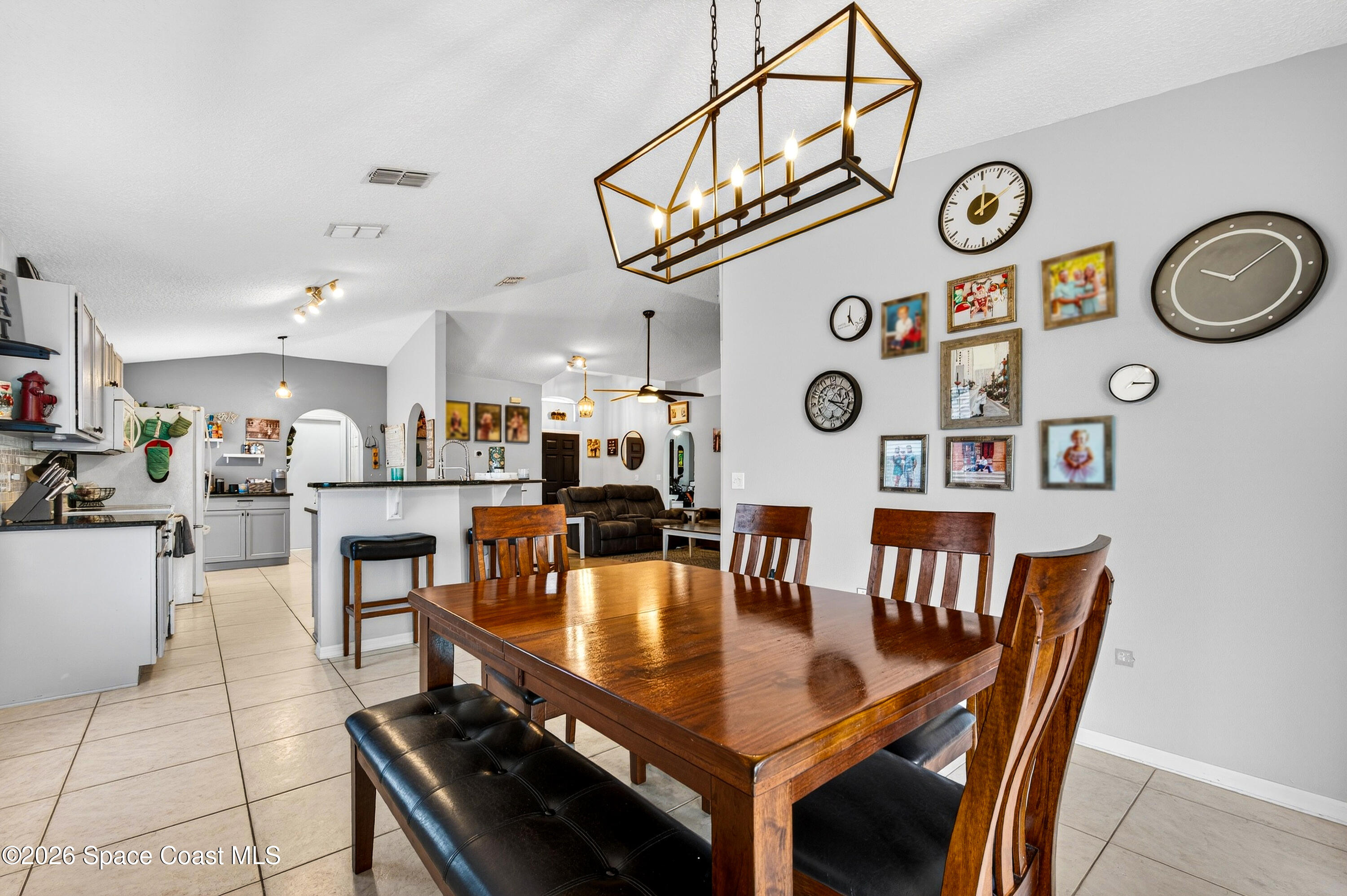 3393 Echo Ridge Place Cocoa, FL 32926 - Photo 22 of 40 a dining room with furniture and a clock