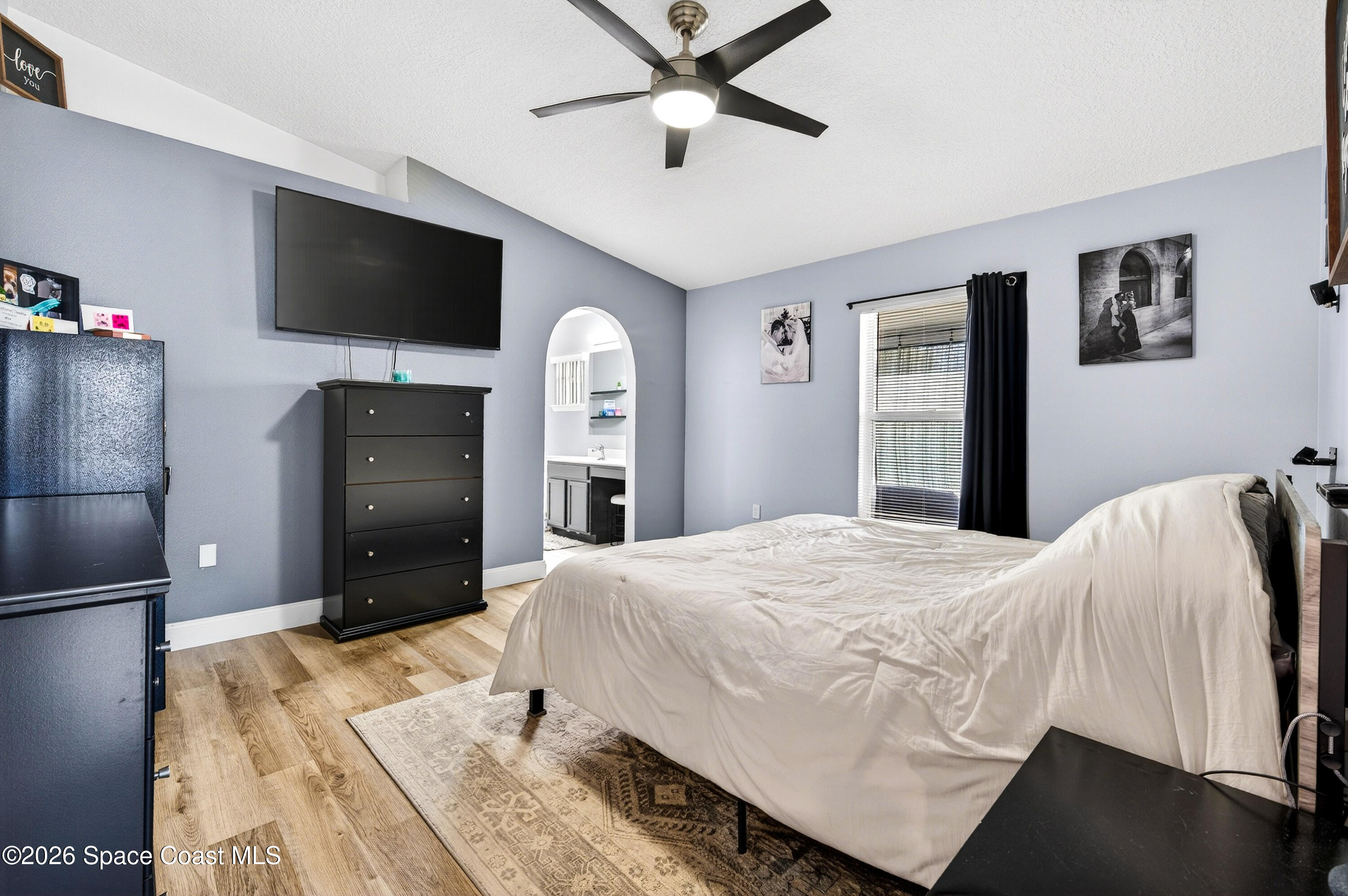 3393 Echo Ridge Place Cocoa, FL 32926 - Photo 25 of 40 a bedroom with a bed and a flat screen tv