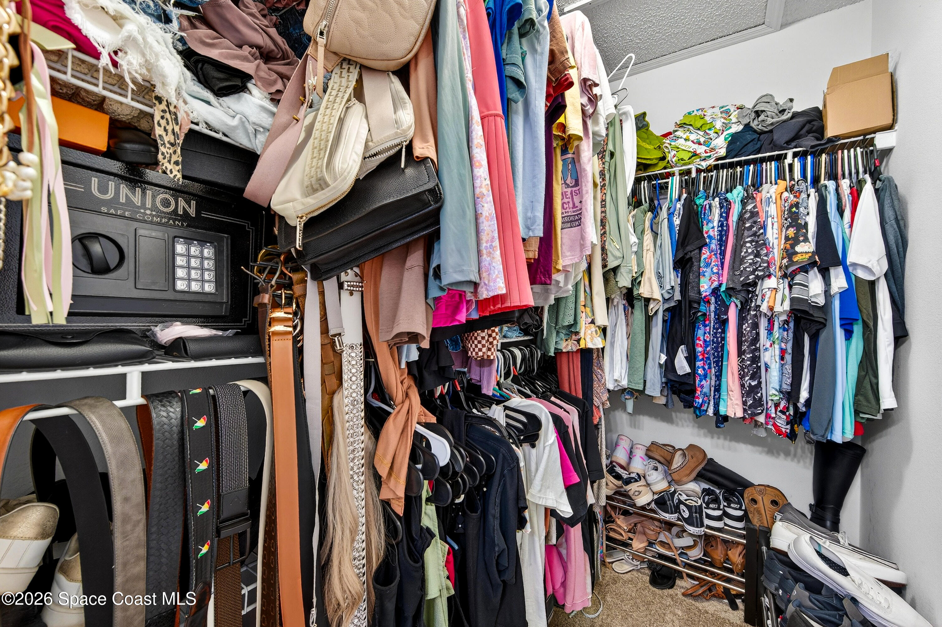 3393 Echo Ridge Place Cocoa, FL 32926 - Photo 29 of 40 a view of walk in closet with clothes