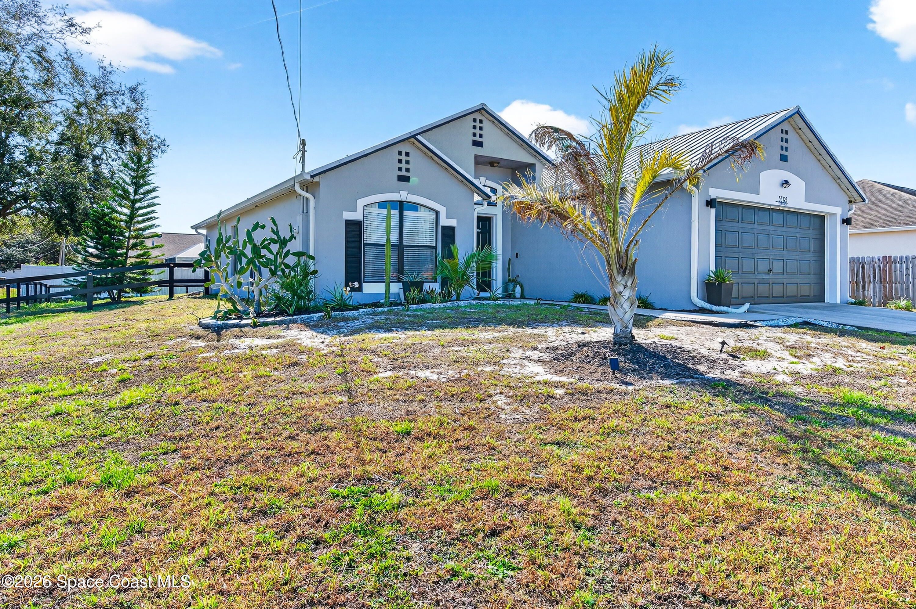 3393 Echo Ridge Place Cocoa, FL 32926 - Photo 3 of 40 a front view of a house with a yard
