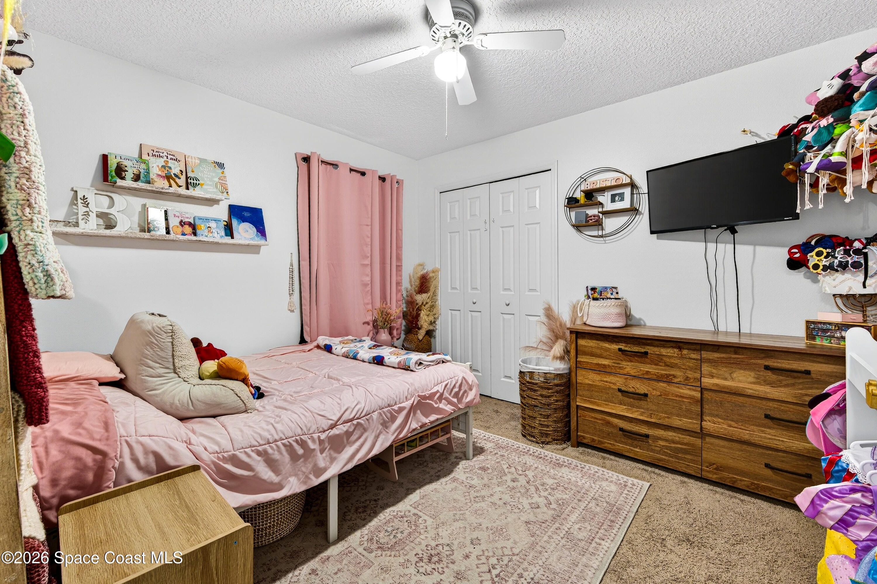 3393 Echo Ridge Place Cocoa, FL 32926 - Photo 32 of 40 a bedroom with a bed and flat screen tv