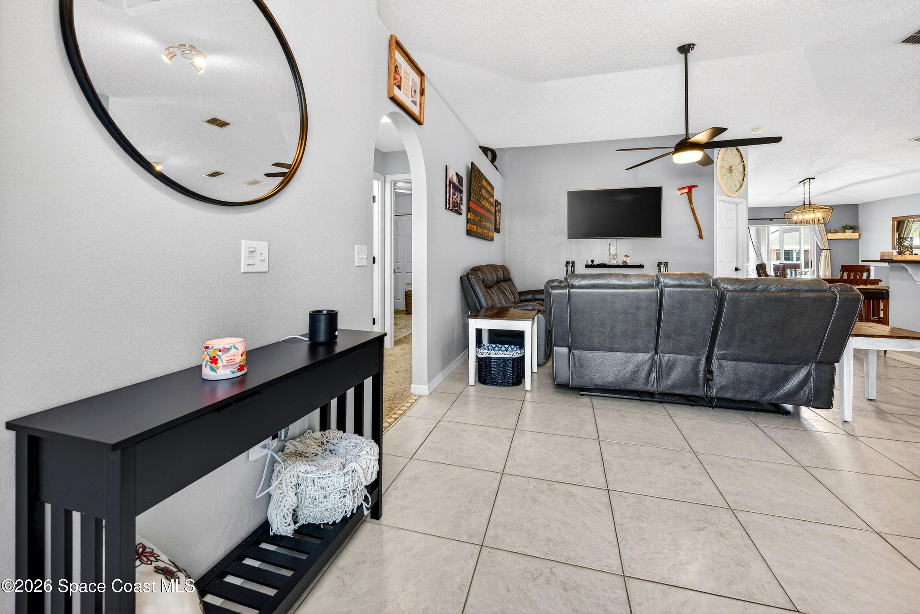 3393 Echo Ridge Place Cocoa, FL 32926 - Photo 6 of 40 a living room with furniture and a flat screen tv