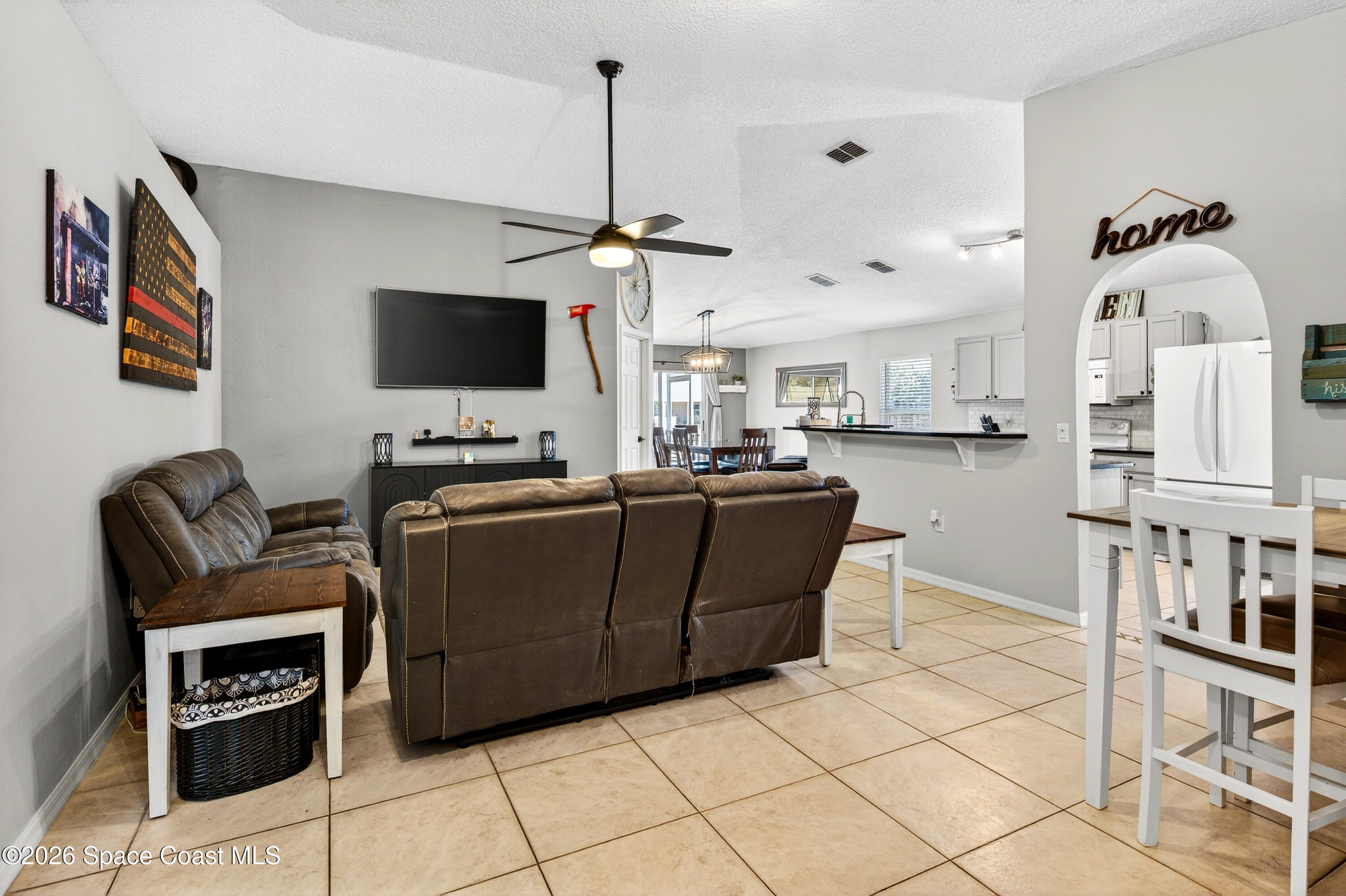 3393 Echo Ridge Place Cocoa, FL 32926 - Photo 8 of 40 a living room with furniture and a flat screen tv
