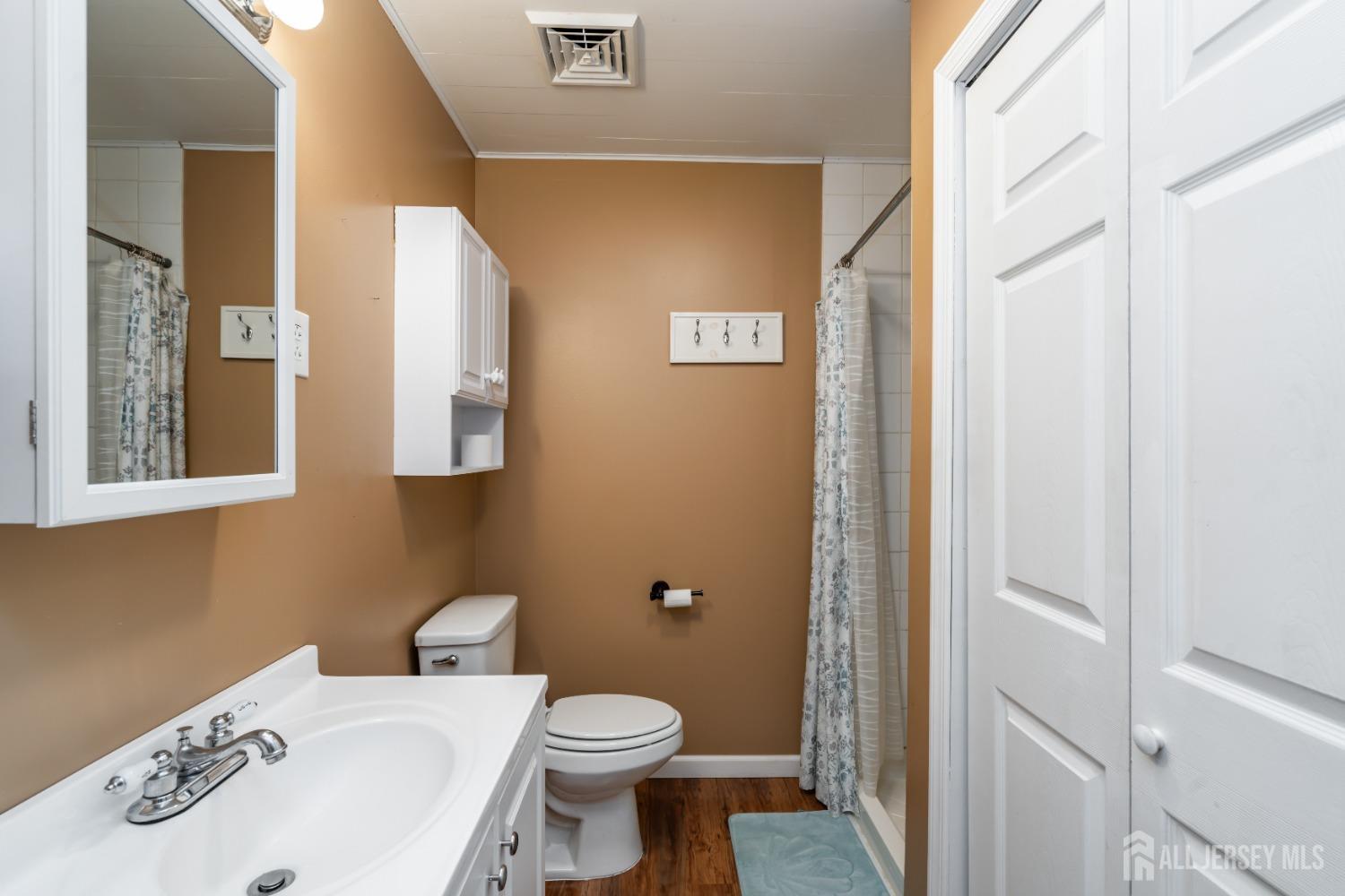 11 Gurley Road Edison, NJ 08817 - Photo 11 of 24 a bathroom with a sink a toilet and a mirror