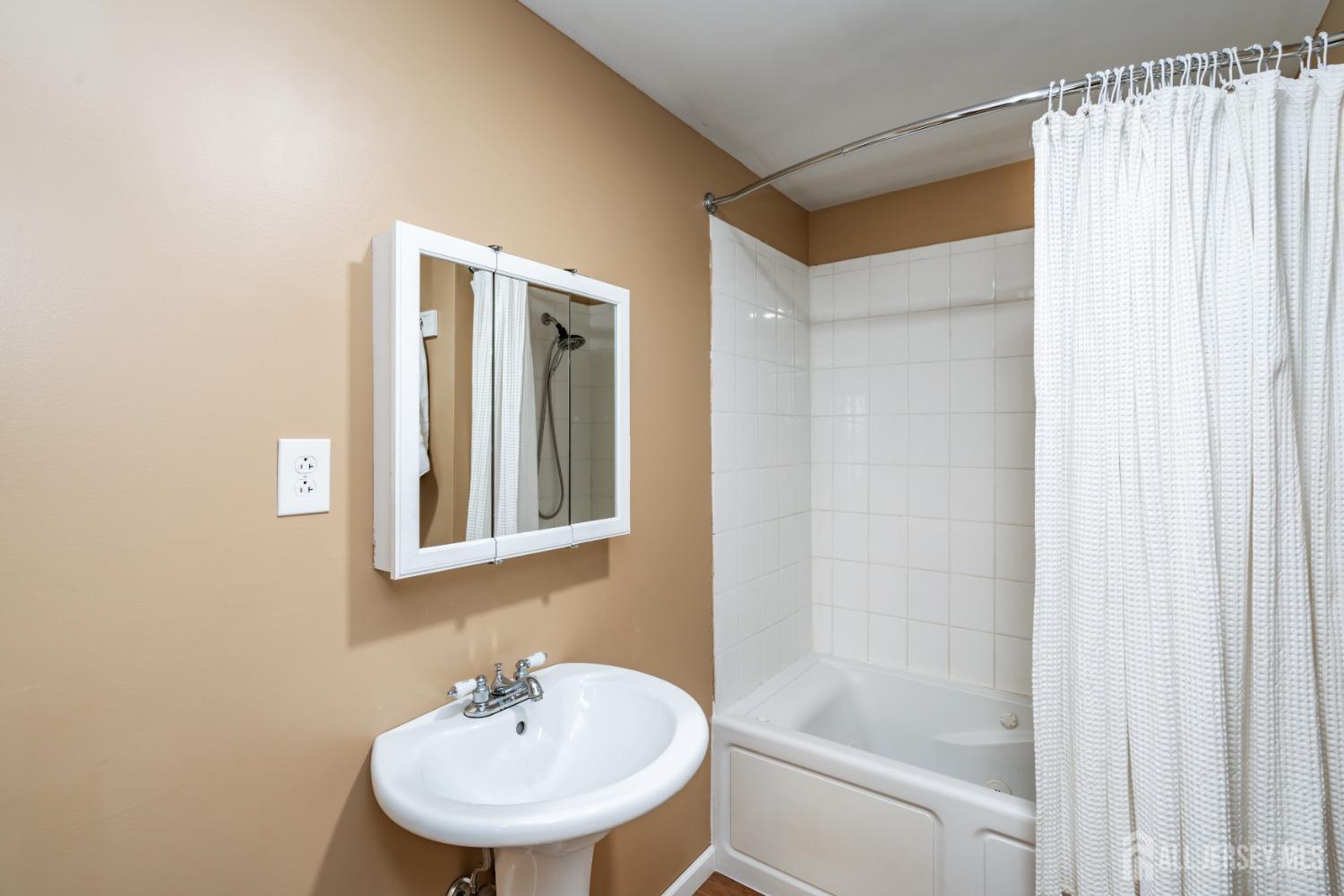 11 Gurley Road Edison, NJ 08817 - Photo 15 of 24 a bathroom with a shower a sink and a mirror
