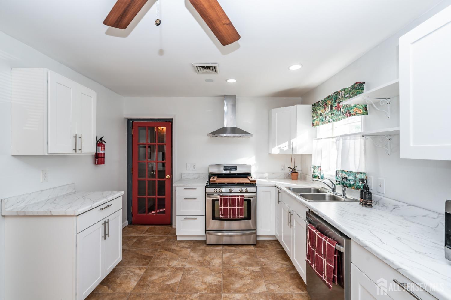 11 Gurley Road Edison, NJ 08817 - Photo 7 of 24 a kitchen with stainless steel appliances granite countertop a stove and a sink