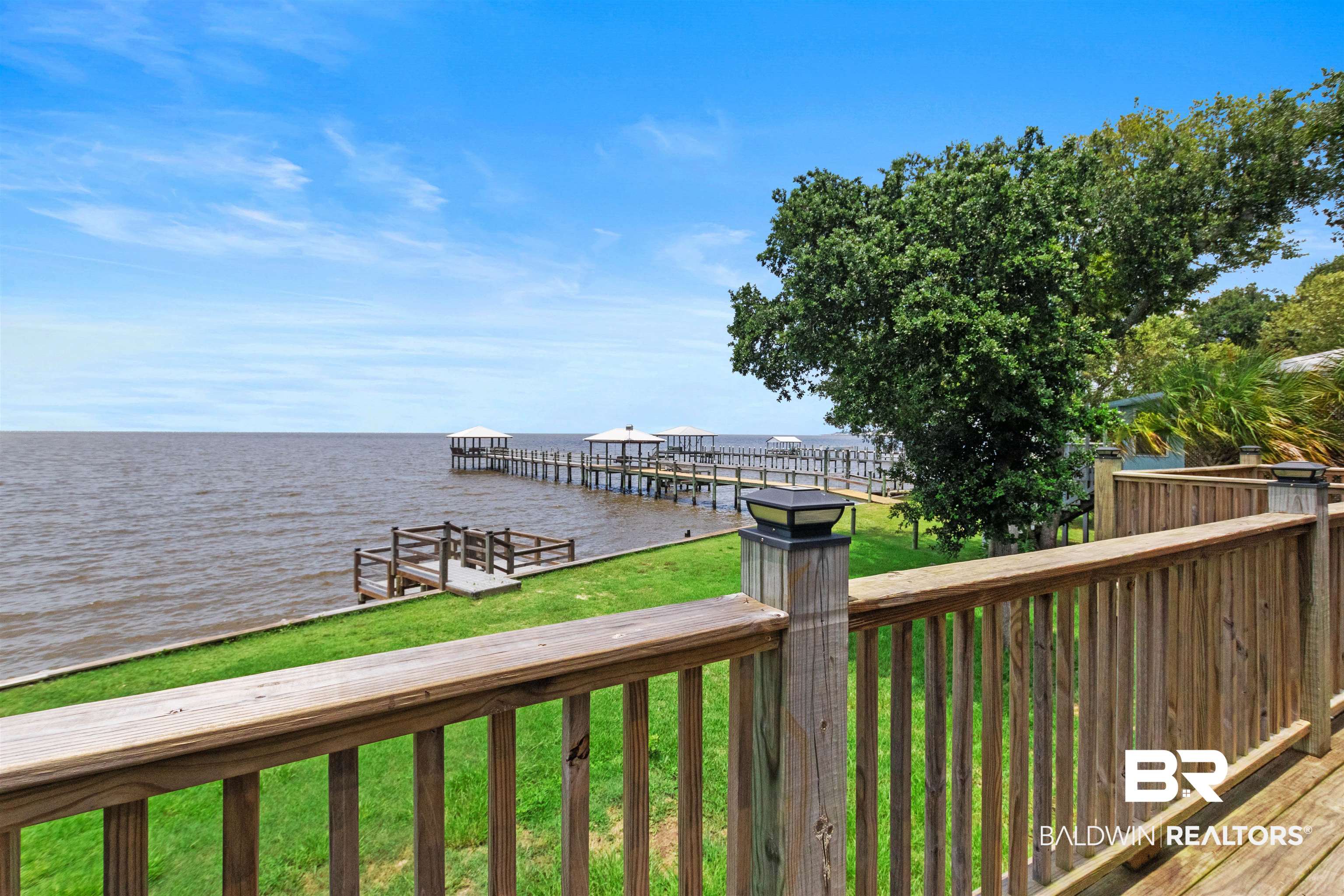 9581 South Bay Street Foley, AL 36535 - Photo 33 of 44 Wood-finish deck with railing overlooking a substantial body of water