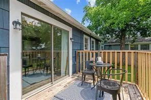 a view of a chair and table in backyard of the house
