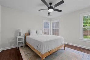 a bedroom with a bed and a large window