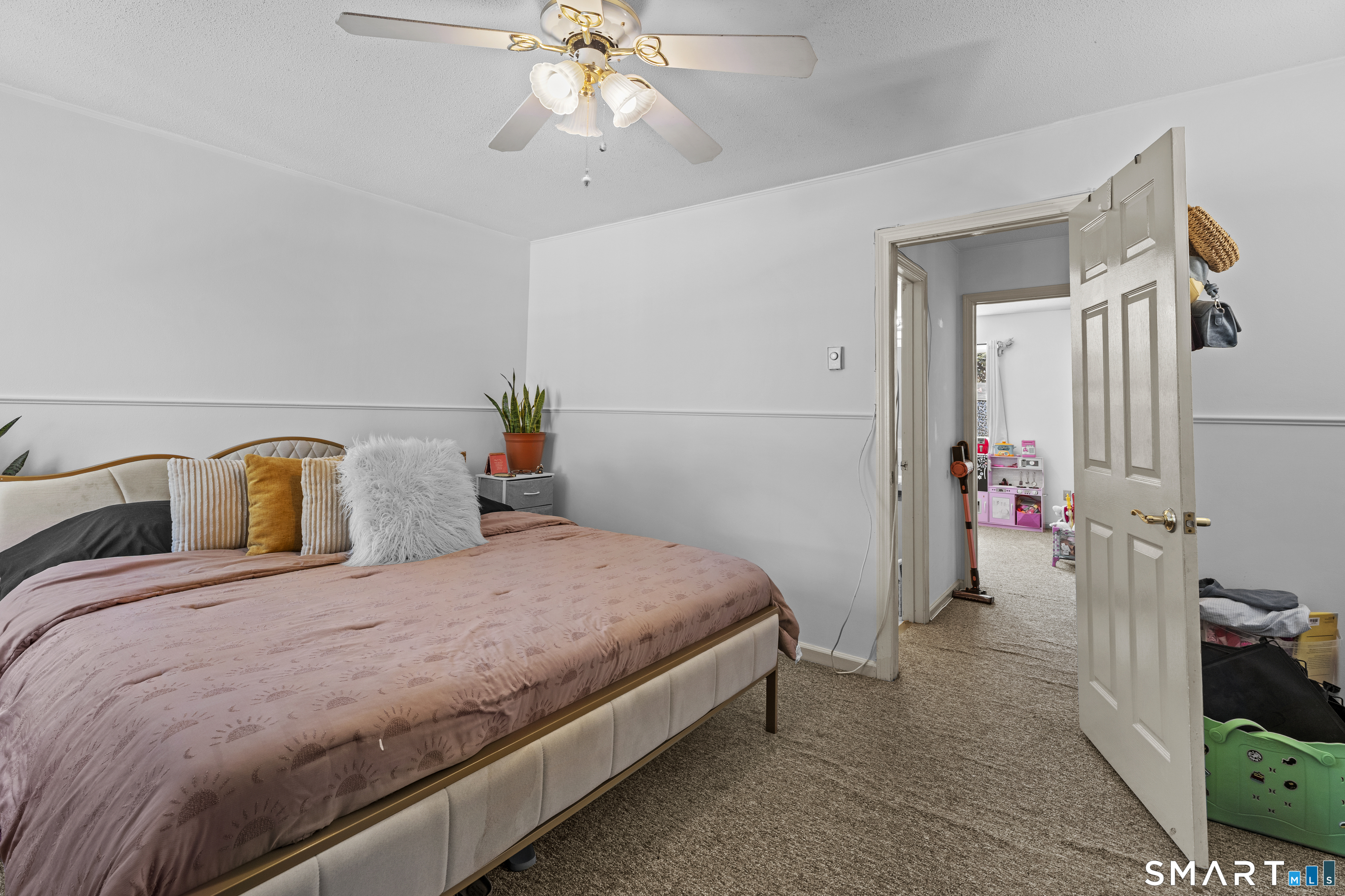 23 Pearl Lake Road, Unit B Waterbury, CT 06706 - Photo 10 of 14 a bedroom with a bed and a chandelier