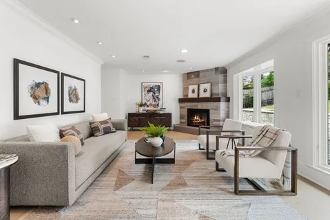 a living room with fireplace furniture and a fireplace