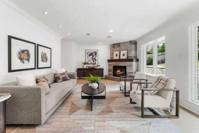 a living room with fireplace furniture and a fireplace