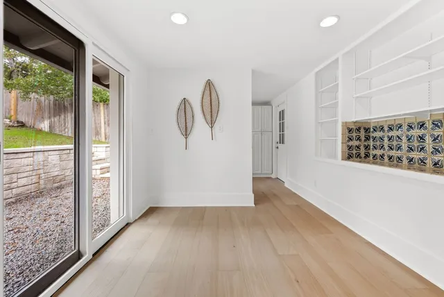 wooden floor in an empty room with a window
