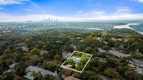 an aerial view of a forest with houses