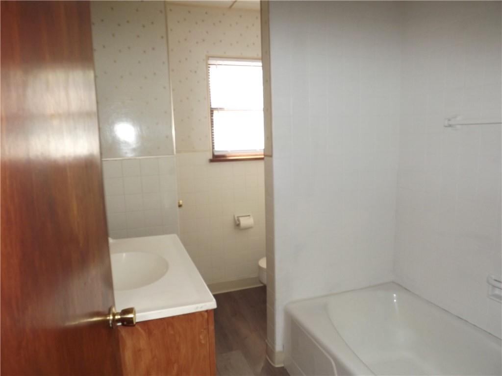 411 Fair Oaks Street McKees Rocks, PA 15136 - Photo 5 of 23 a bathroom with a sink and tub