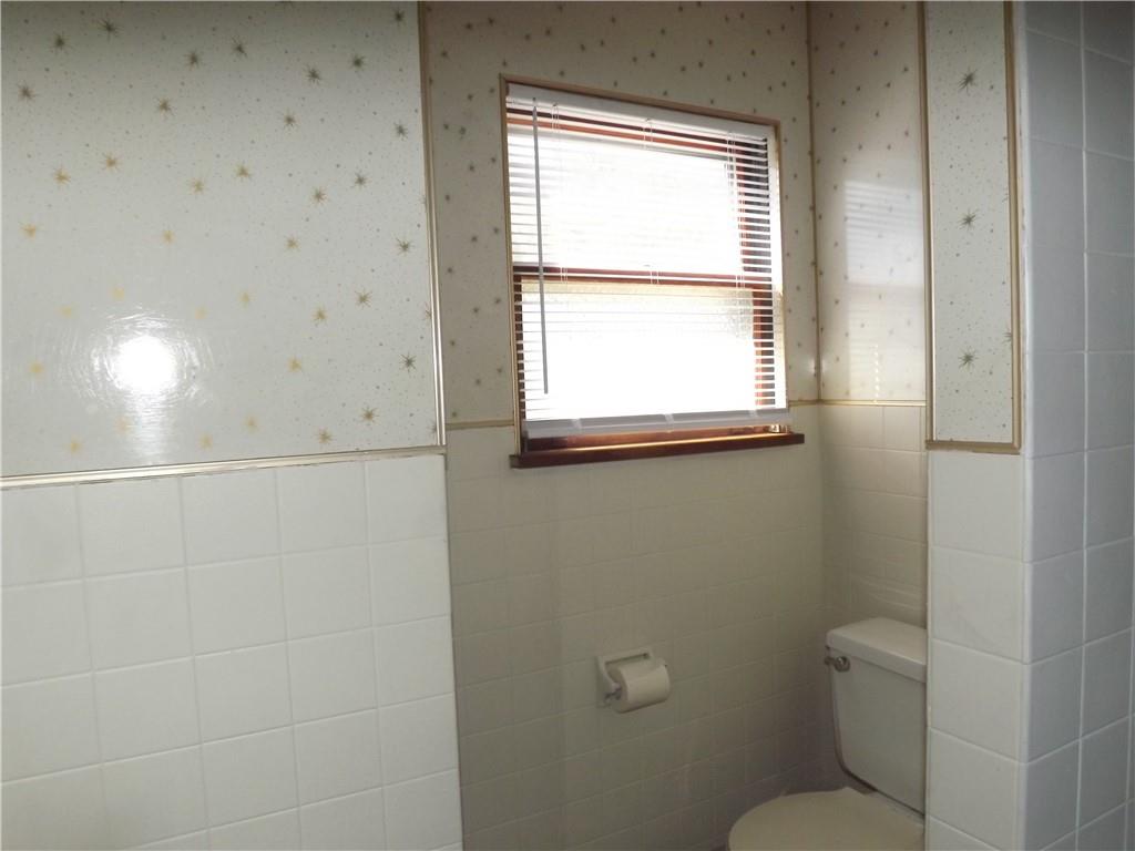 411 Fair Oaks Street McKees Rocks, PA 15136 - Photo 8 of 23 a bathroom with a toilet a sink and a window