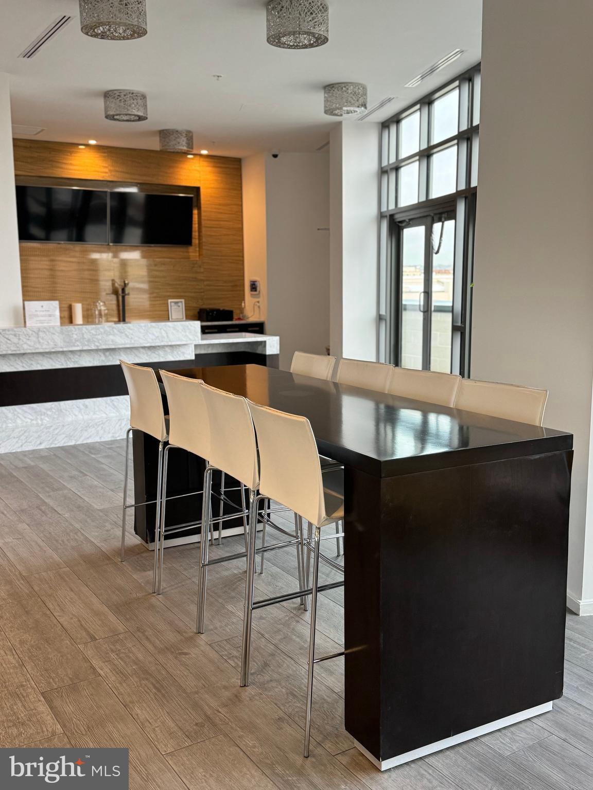 460 New York Avenue Northwest, Unit 407 Washington, DC 20001 - Photo 23 of 64 a kitchen with a table chairs and a window