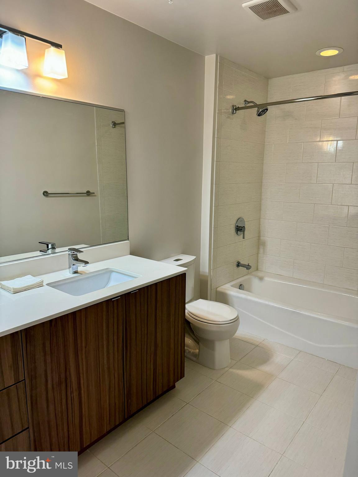 460 New York Avenue Northwest, Unit 407 Washington, DC 20001 - Photo 38 of 64 a bathroom with a double vanity sink toilet mirror and shower