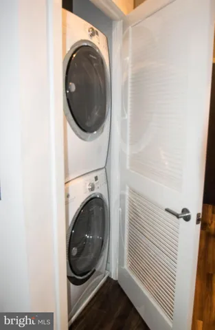 a kitchen with stainless steel appliances granite countertop a sink dishwasher a stove refrigerator and cabinets with wooden floor