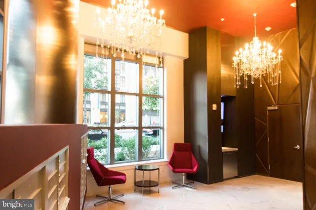 a living room with furniture and a floor to ceiling window