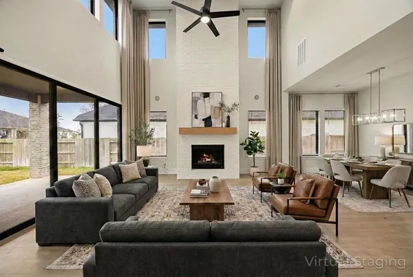 a living room with furniture fireplace and a large window