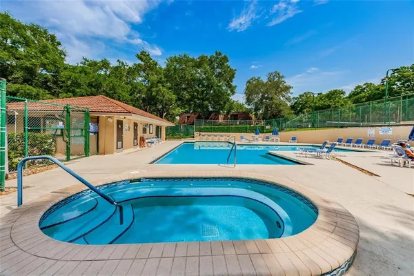 a view of a house with swimming pool and sitting area
