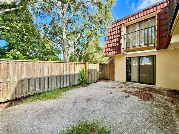 a view of a house with wooden fence