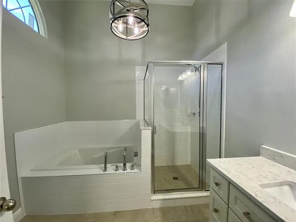 a bathroom with a shower and a sink