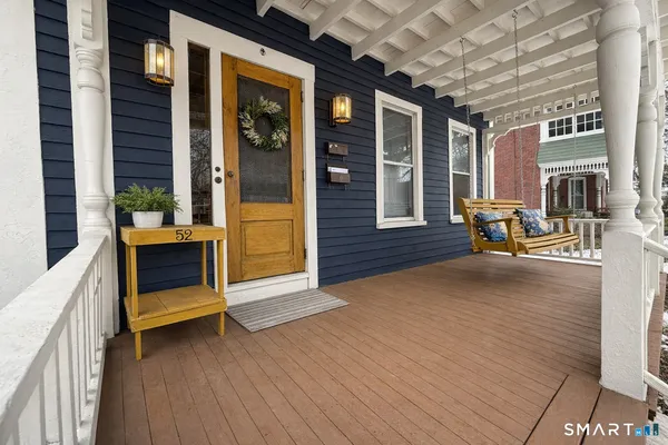 a view of an empty room with a fireplace and wooden floor