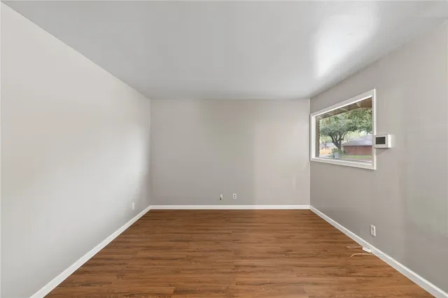 a view of room with wooden floor and window